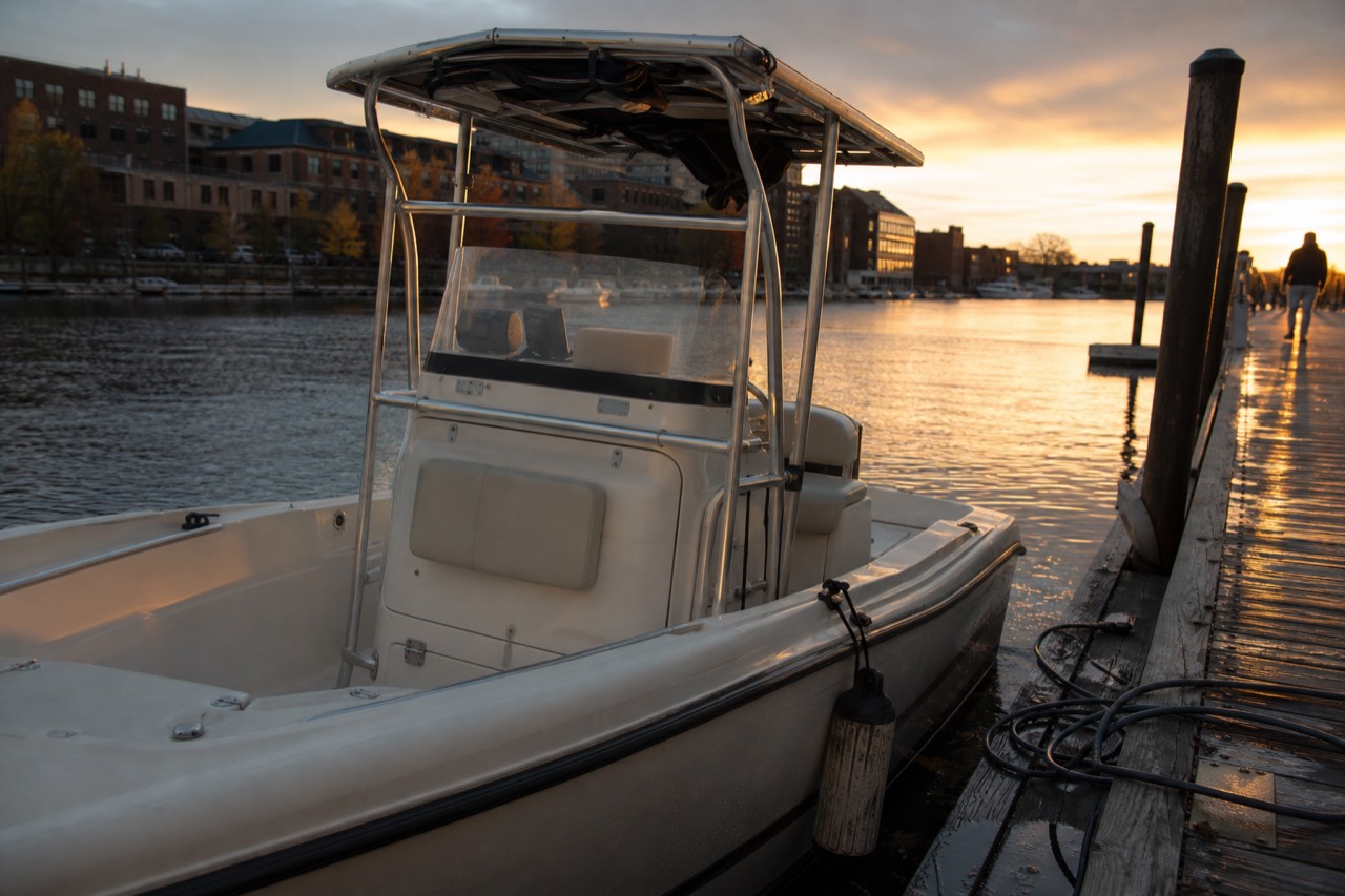 Small motorboat tied at a Charleston dock at golden hour, no text, no logos, no people