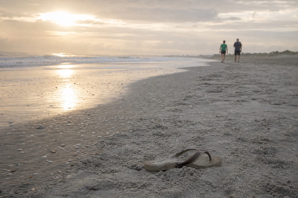 Ocean waves rolling onto a wide Lowcountry beach at sunrise, no text, no logos, no people