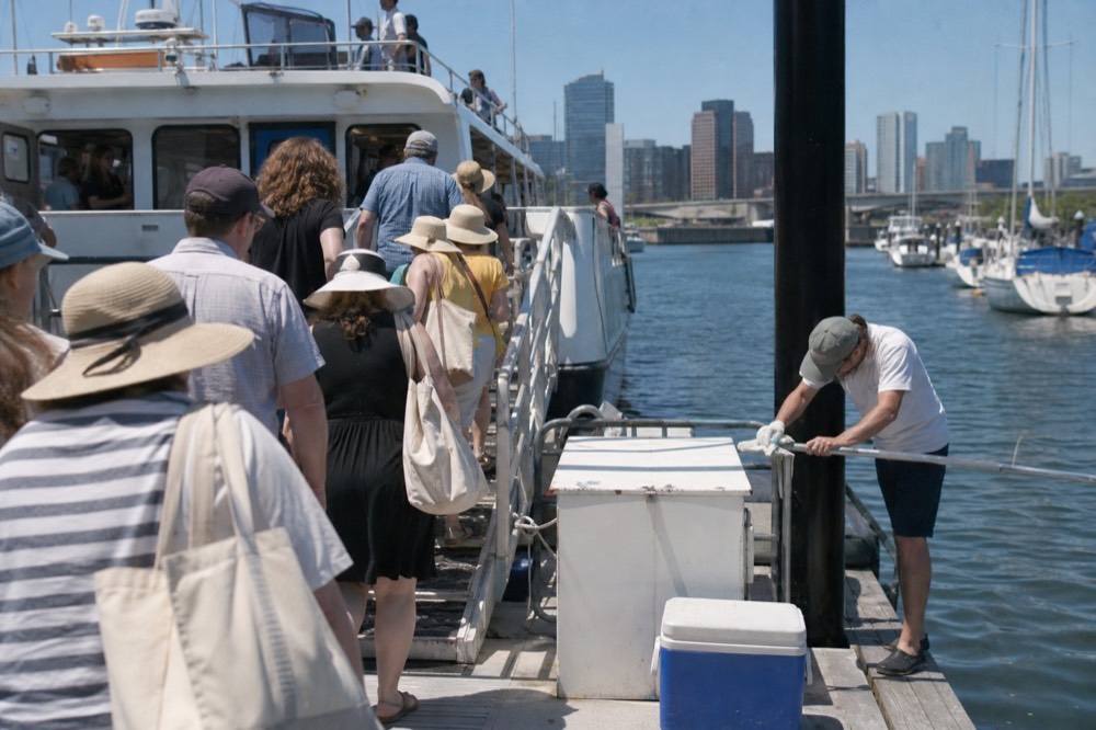Passengers boarding a sightseeing boat at a downtown Charleston marina dock, no text, no logos, no people