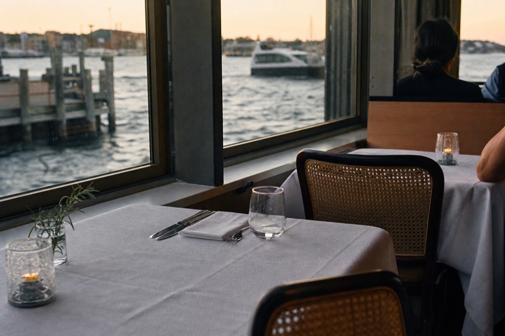 A set dinner table on a climate-controlled cruise dining deck, no text, no logos, no people