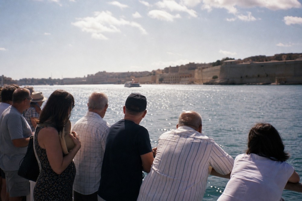 Passengers aboard a historic harbor cruise boat watching Fort Sumter from the water, no text, no logos, no people