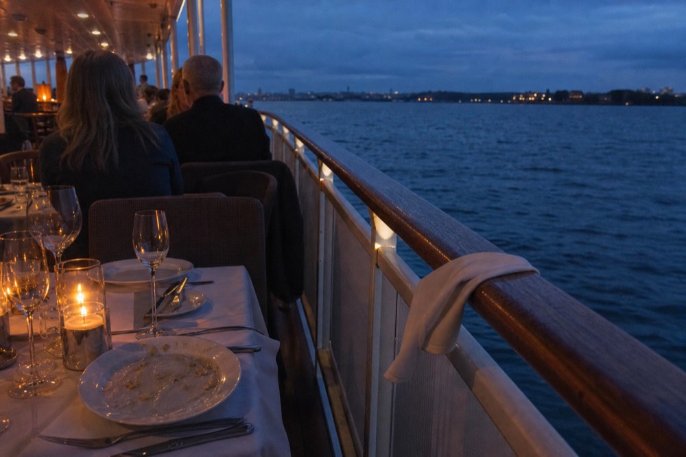 Dinner cruise table setting on boat, no text, no logos, no people