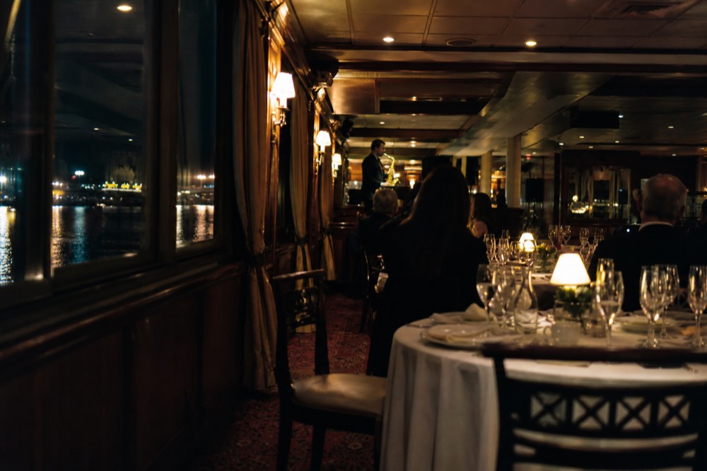 Luxury dinner cruise interior with live music, no text, no logos, no people